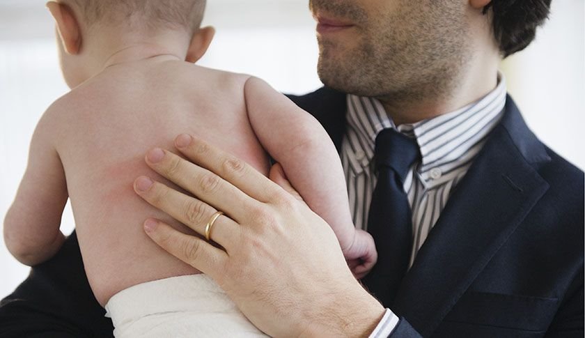 Businessman consoling baby